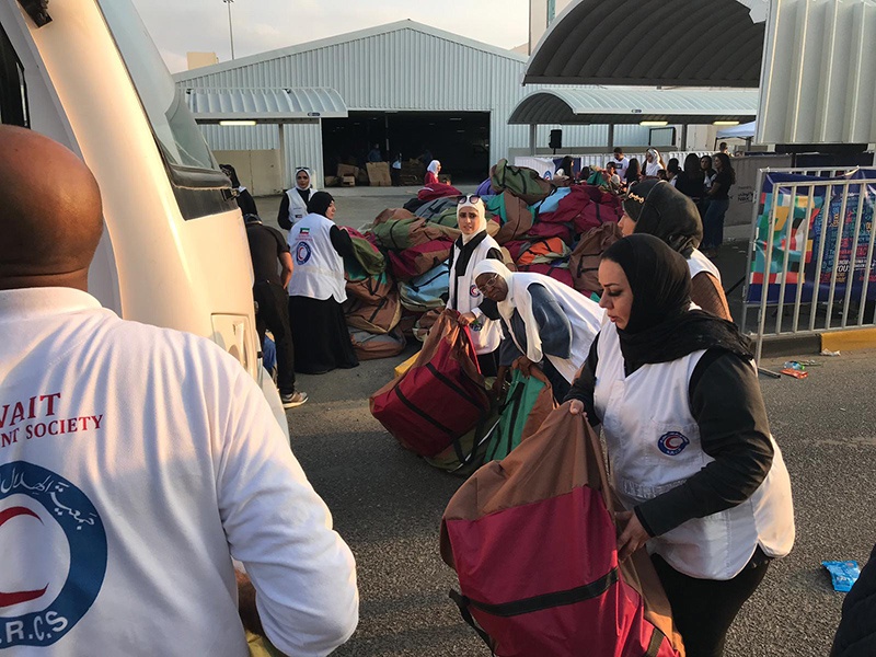 KUWAIT: KRCS workers distribute goods to cleaners as part of its 'warm winter' campaign.