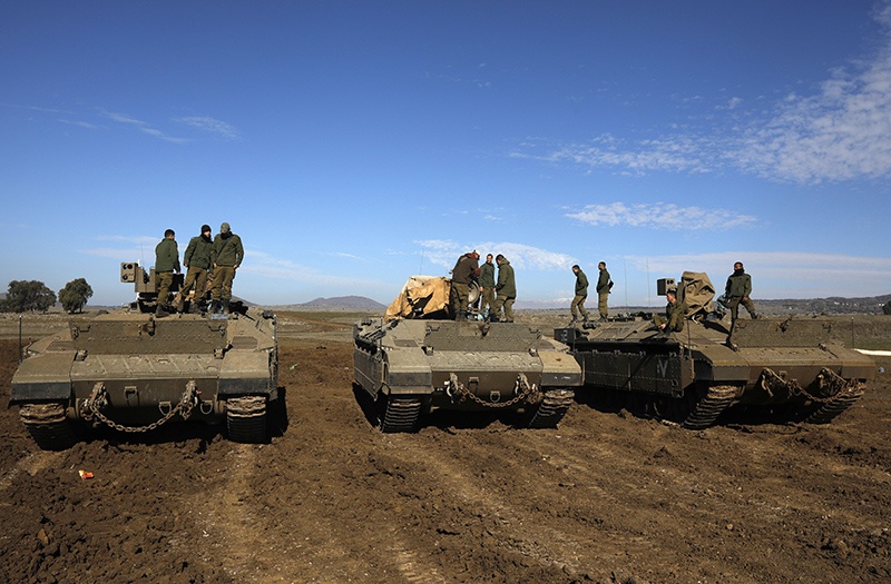 Israeli troops are pictured in the Israeli-annexed Golan Heights on the border with Syria on December 23, 2019. - A war monitor said today that air raids in Syria the previous night, blamed on Israel, killed at least three foreign pro-regime fighters south of the war-torn country's capital.  The Britain-based Syrian Observatory for Human Rights said Sunday night's attack hit Syrian regime and Iranian positions south of Damascus. It said three non-Syrian loyalist fighters were killed by a rocket blast between the suburb of Aqraba and the nearby Sayyida Zeinab neighbourhood, home to a shrine revered by Shiite Muslims. (Photo by JALAA MAREY / AFP)