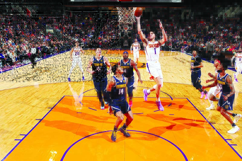 PHOENIX, AZ - DECEMBER 23: Devin Booker #1 of the Phoenix Suns shoots the ball during the game against the Denver Nuggets on December 23, 2019 at Talking Stick Resort Arena in Phoenix, Arizona. NOTE TO USER: User expressly acknowledges and agrees that, by downloading and or using this photograph, user is consenting to the terms and conditions of the Getty Images License Agreement. Mandatory Copyright Notice: Copyright 2019 NBAE   Barry Gossage/NBAE via Getty Images/AFP