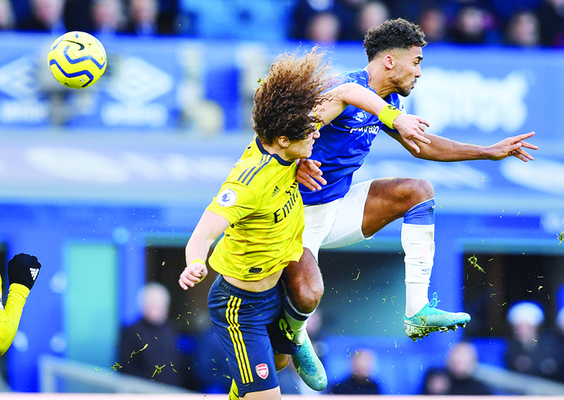 Arsenal's Brazilian defender David Luiz (L) vies with Everton's English striker Dominic Calvert-Lewin during the English Premier League football match between Everton and Arsenal at Goodison Park in Liverpool, north west England on December 21, 2019. (Photo by Paul ELLIS / AFP) / RESTRICTED TO EDITORIAL USE. No use with unauthorized audio, video, data, fixture lists, club/league logos or 'live' services. Online in-match use limited to 120 images. An additional 40 images may be used in extra time. No video emulation. Social media in-match use limited to 120 images. An additional 40 images may be used in extra time. No use in betting publications, games or single club/league/player publications. /