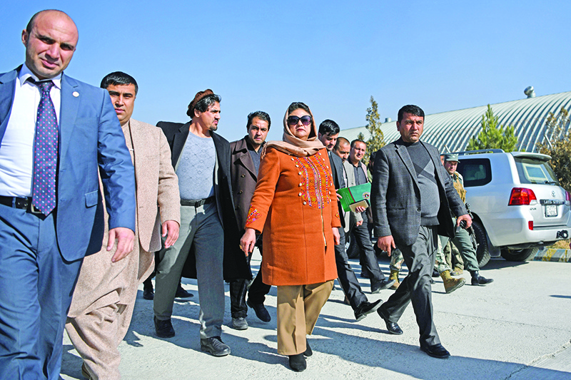 KABUL: Head of the Afghan Independent Election Commission (IEC) Hawa Alam Nuristani leaves after announcing the preliminary elections results in Kabul yesterday.-AFP
