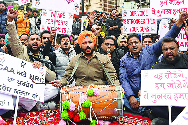 Activists of the Youth Congress hold placards and shout slogans during a protest†against India's new citizenship law in Amritsar on December 24, 2019. - The wave of protests across the country marks the biggest challenge to Modi's government since sweeping to power in the world's largest democracy in 2014 . (Photo by NARINDER NANU / AFP)