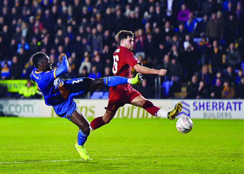 Shrewsbury Town's Grenadian defender Aaron Pierre (L) shoots past Liverpool's Welsh midfielder Neco Williams (R) during the English FA Cup fourth round football match between between Shrewsbury Town and Liverpool at the Montgomery Waters Meadow Stadium in Shrewsbury, north-west of Birmingham in England on January 26, 2020. (Photo by Anthony Devlin / AFP) / RESTRICTED TO EDITORIAL USE. No use with unauthorized audio, video, data, fixture lists, club/league logos or 'live' services. Online in-match use limited to 120 images. An additional 40 images may be used in extra time. No video emulation. Social media in-match use limited to 120 images. An additional 40 images may be used in extra time. No use in betting publications, games or single club/league/player publications. /