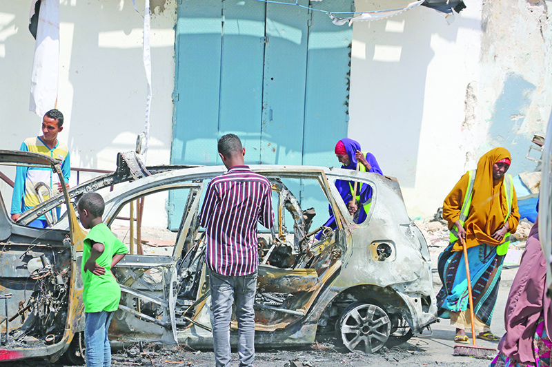 People start cleaning debris at the site where a car bomb exploded near the Somali parliament in Mogadishu, Somalia, on January 8, 2020. - At least four people were killed and 10 wounded when a car bomb exploded close to a checkpoint near Somalia's parliament in the capital Mogadishu on January 8, 2020, police said. (Photo by Abdirazak Hussein FARAH / AFP)