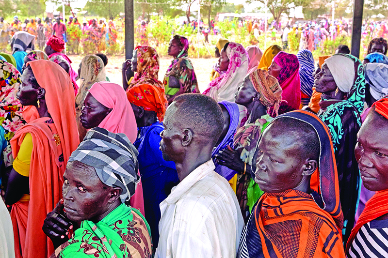 Members of the local host community wait in line for the distribution of emergency household items like soap, blankets and wash basins following intense flooding in Maban, South Sudan on November 26, 2019. - Large areas of eastern South Sudan have been affected by heavy rains in the past months, leaving an estimated 420,000 people displaced from their homes. (Photo by Alex McBride / AFP)
