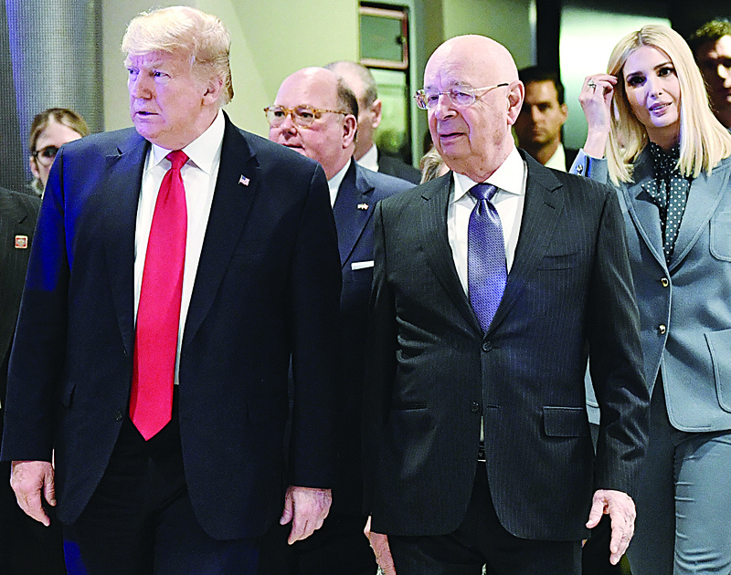 US president Donald Trump (L), World Economic Forum (WEF) founder and executive chairman Klaus Schwab (C) and White House Senior Advisor Ivanka Trump (R), arrive at the Congress center during the World Economic Forum (WEF) annual meeting in Davos, on January 22, 2020. (Photo by Fabrice COFFRINI / AFP)