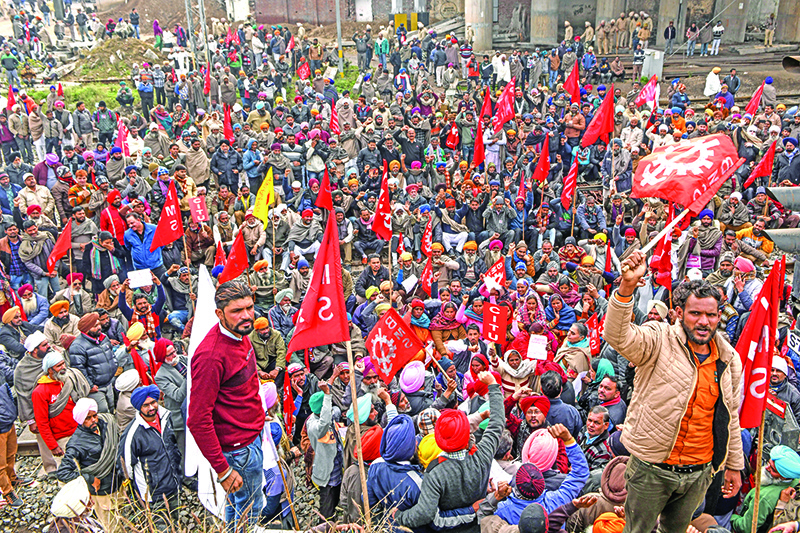 Activists of†Communist Party of India Marxist (CPIM), along with members of different workers unions,†shout slogans as they block train tracks during a nationwide general strike called by trade unions aligned with opposition parties to protest against the Indian government's economic policies, near the railway station in Amritsar on January 8, 2020. - Millions went on strike throughout India on January 8, unions said, as workers angry at the government's labour policies brought travel chaos across the country. (Photo by NARINDER NANU / AFP)