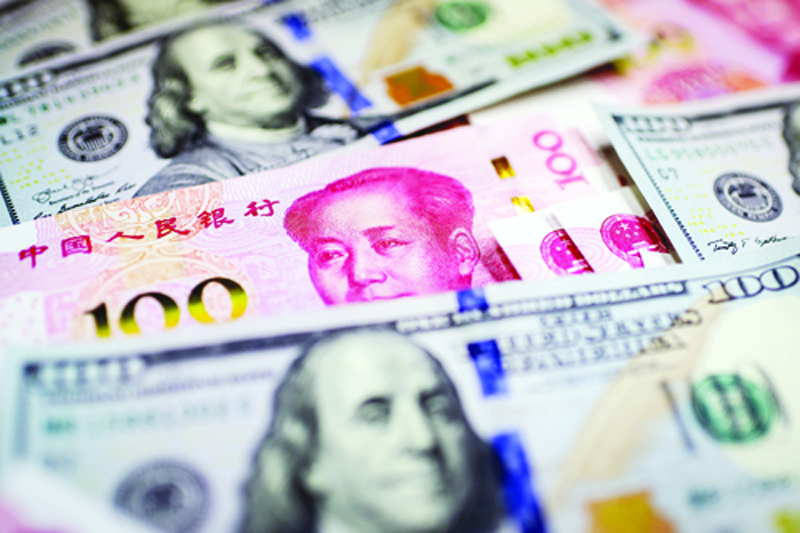 This photo illustration shows a Chinese 100 yuan notes (red color) and US 100 notes in Beijing on January 14, 2020. - The United States removed the currency manipulator label it imposed on China last summer, a sign of easing tensions between the economic powers after nearly two years of conflict. Separately, official data showed that Chinaís trade surplus with the United States narrowed in 2019, a day before the two countries sign a ìphase oneî trade deal in Washington. (Photo by NICOLAS ASFOURI / AFP)