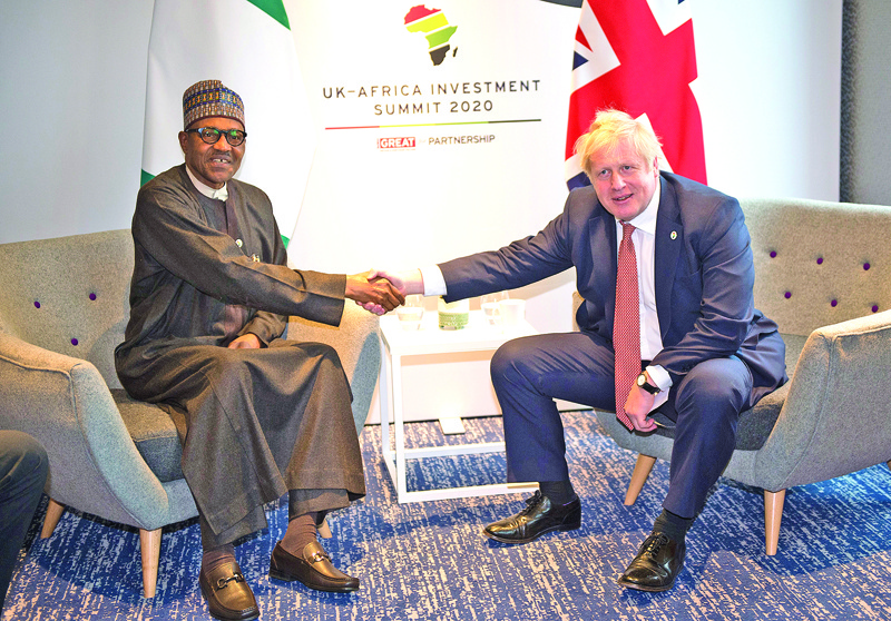 Britain's Prime Minister Boris Johnson (R) poses with Nigeria's President Muhammadu Buhari during their bilateral meeting at the UK-Africa Investment Summit in London on January 20, 2020. (Photo by Eddie MULHOLLAND / POOL / AFP)