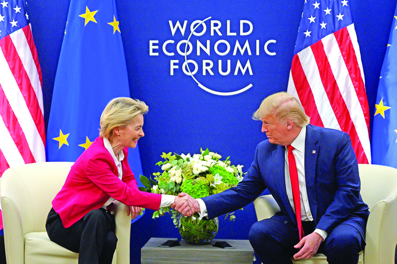 US President Donald Trump shakes hands with European Commission President Ursula von der Leyen prior to their meeting at the World Economic Forum in Davos, on January 21, 2020. (Photo by JIM WATSON / AFP)