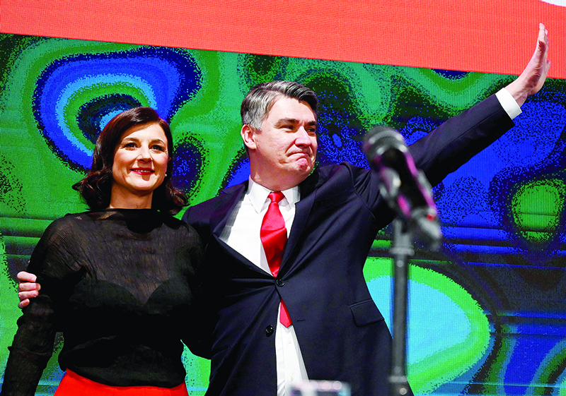 Presidential candidate of the Social Democratic Party of Croatia Zoran Milanovic (R) waves  flanked by his wife Sanja Music Milanovic on January 15, 2020, in Zagreb, as they celebrate winning following initial results in Croatia's presidential election. - A leftist former prime minister, who has pledged to make Croatia a tolerant country turning the page on its wartime past, has defeated the incumbent conservative in a presidential run-off vote on January 5, official results showed. (Photo by Denis LOVROVIC / AFP)