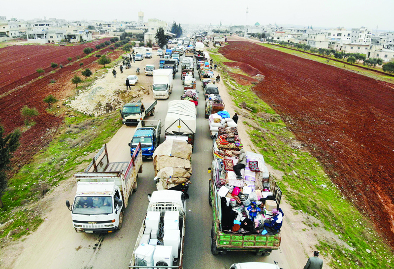 TOPSHOT - A aerial photo shows displaced Syrians driving through Hazano in the northern countryside of Idlib, after fleeing on January 28, 2020 its southern countryside towards areas further north near the border with Turkey, as a result of an ongoing offensive by regime forces on Syria's rebel-held northwestern region. - Syrian regime forces were poised to soon enter Maaret al-Numan, a town of symbolic and strategic importance that is deserted after months of bombardment, in the country's last major opposition bastion of Idlib. (Photo by Omar HAJ KADOUR / AFP)