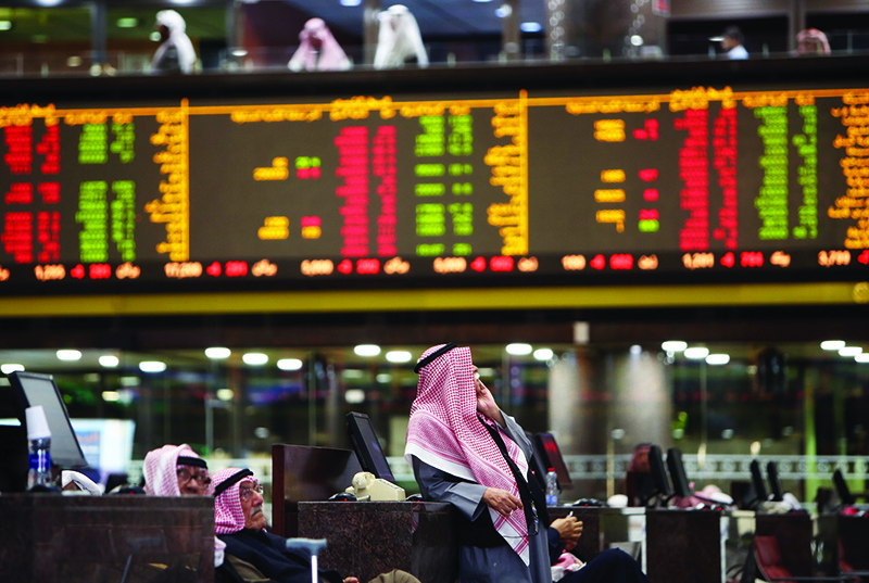 Kuwaiti traders follow the stock market at Boursa Kuwait, in Kuwait City on January 6, 2020.
