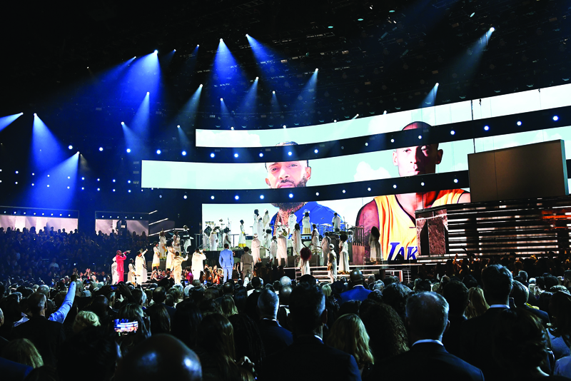 LOS ANGELES, CALIFORNIA - JANUARY 26: Images for the late Nipsey Hussle and Kobe Bryant are projected onto a screen while YG, John Legend, Kirk Franklin, DJ Khaled, Meek Mill, and Roddy Ricch perform onstage during the 62nd Annual GRAMMY Awards at Staples Center on January 26, 2020 in Los Angeles, California.   Kevork Djansezian/Getty Images/AFPn== FOR NEWSPAPERS, INTERNET, TELCOS &amp; TELEVISION USE ONLY ==