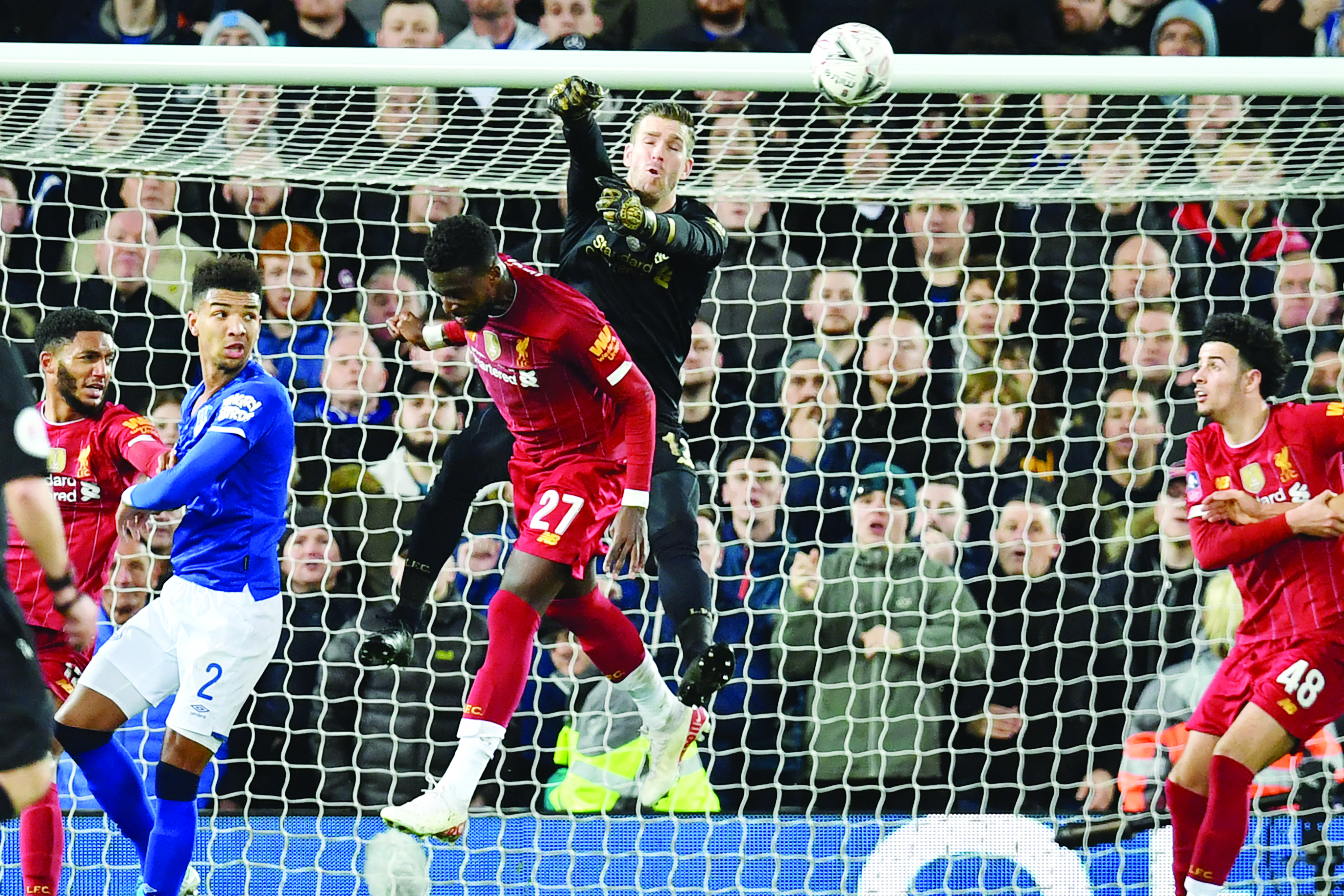 Liverpool's Spanish goalkeeper Adrian (C) punches the ball clear during the English FA Cup third round football match between Liverpool and Everton at Anfield in Liverpool, north west England on January 5, 2020. (Photo by Paul ELLIS / AFP) / RESTRICTED TO EDITORIAL USE. No use with unauthorized audio, video, data, fixture lists, club/league logos or 'live' services. Online in-match use limited to 120 images. An additional 40 images may be used in extra time. No video emulation. Social media in-match use limited to 120 images. An additional 40 images may be used in extra time. No use in betting publications, games or single club/league/player publications. /