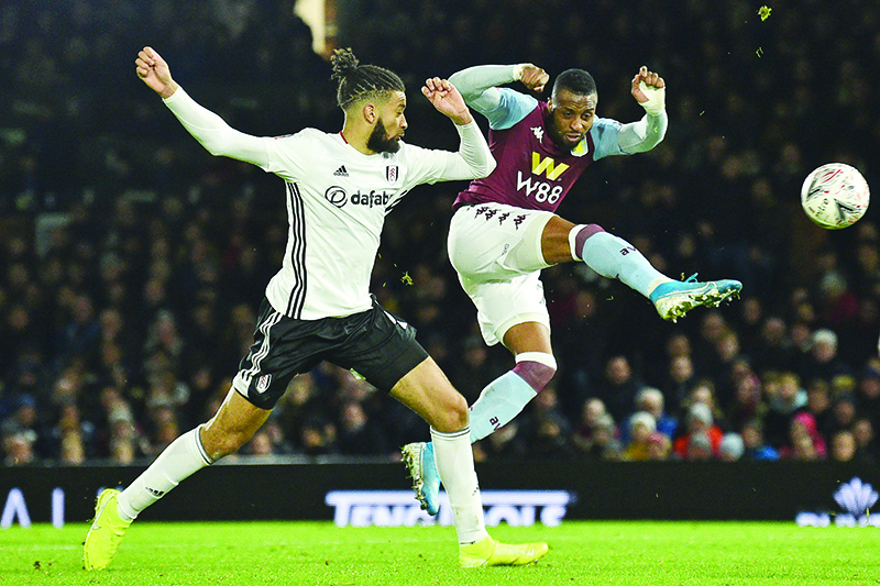 Aston Villa's Ivorian striker Jonathan Kodjia (R) has an unsuccessful shot during the English FA Cup third round football match between Fulham and Aston Villa at Craven Cottage in Fulham, west London on January 4, 2020. (Photo by Glyn KIRK / AFP) / RESTRICTED TO EDITORIAL USE. No use with unauthorized audio, video, data, fixture lists, club/league logos or 'live' services. Online in-match use limited to 120 images. An additional 40 images may be used in extra time. No video emulation. Social media in-match use limited to 120 images. An additional 40 images may be used in extra time. No use in betting publications, games or single club/league/player publications. /