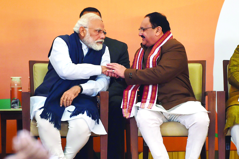 Bharatiya Janata Party (BJP) new president Jagat Prakash Nadda (R) shakes hand with Indian Prime Minister Narendra Modi during an event at the BJP headquarters, in New Delhi on January 20, 2020. (Photo by Money SHARMA / AFP)