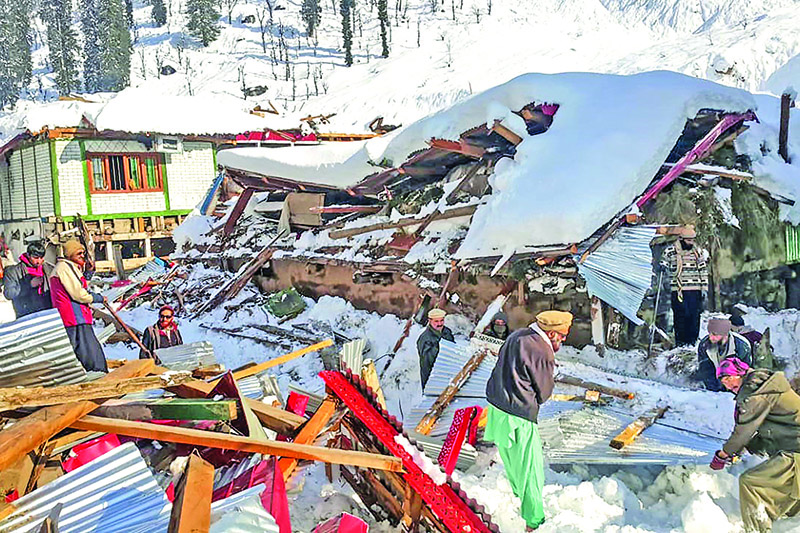 Local residents remove debris of a collapsed house following heavy snowfall that triggered an avalanche in Neelum Valley, in Pakistan-administered Kashmir on January 14, 2020. - At least 42 people were killed and 21 wounded after heavy snowfall and rain hit Pakistan-administered Kashmir and the country's southwest, officials said. (Photo by STR / AFP)