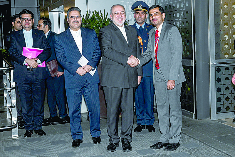 Iran's Foreign Minister Mohammad Javad Zarif (C) shakes hands with an official as he arrives at the Indira Gandhi International Airport in New Delhi on January 14, 2020. (Photo by Money SHARMA / AFP)