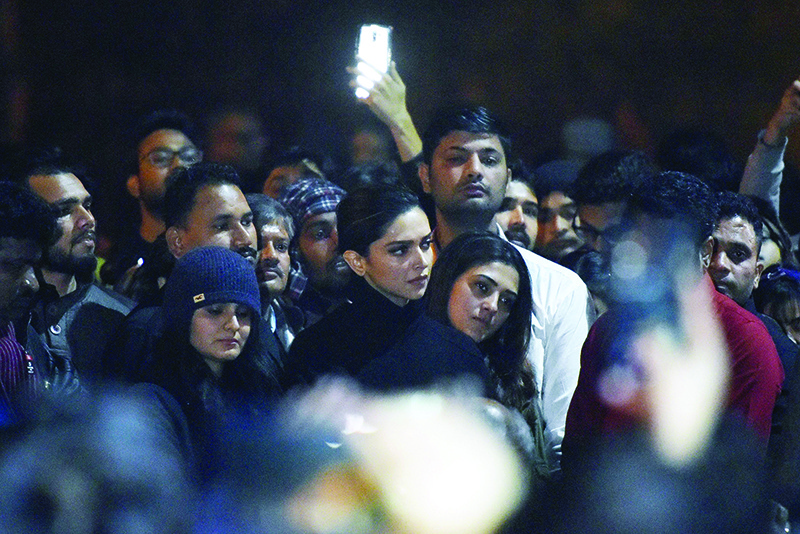 In this photo taken on January 7, 2020, Bollywood actress Deepika Padukone (C) visits students protesting at Jawaharlal Nehru University (JNU) against a recent attack at JNU on students and teachers in New Delhi. - Protests have been held across India after masked assailants wielding batons and iron rods went on a rampage at a top Delhi university, leaving more than two dozen injured. (Photo by STR / AFP)