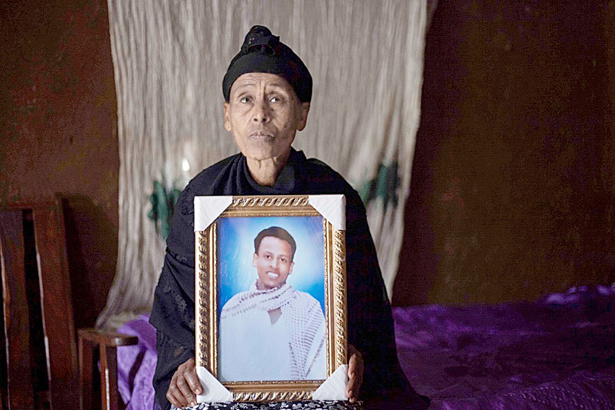 Likitu Merdasa holds a portrait of her son Desta Garuma, a 27-year-old rickshaw driver, allegedly killed by security forces, while at her home in Nekemte, West Oromia, on February 26, 2020. - The killing is one of an array of abuses that residents, opposition politicians and rights groups accuse soldiers of committing in and around Nekemte, a market town in Ethiopia's Oromia region, as part of a crackdown on rebels that has intensified this year. (Photo by SOLAN KOLLI / AFP)