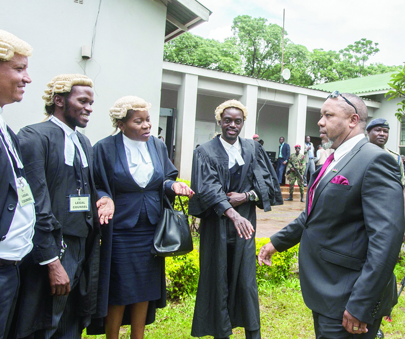 Re-instated Malawi's Vice President Saulos Klaus Chilima (R) greets lawyers on February 3, 2020, in Lilongwe, prior a Malawi constitutional court ruling which annulled the results of a May 2019 vote that re-elected the then incumbent president. - Malawi's main opposition party  welcomed the constitutional court's decision to annul last year's presidential election results over irregularities and vote rigging. (Photo by AMOS GUMULIRA / AFP)