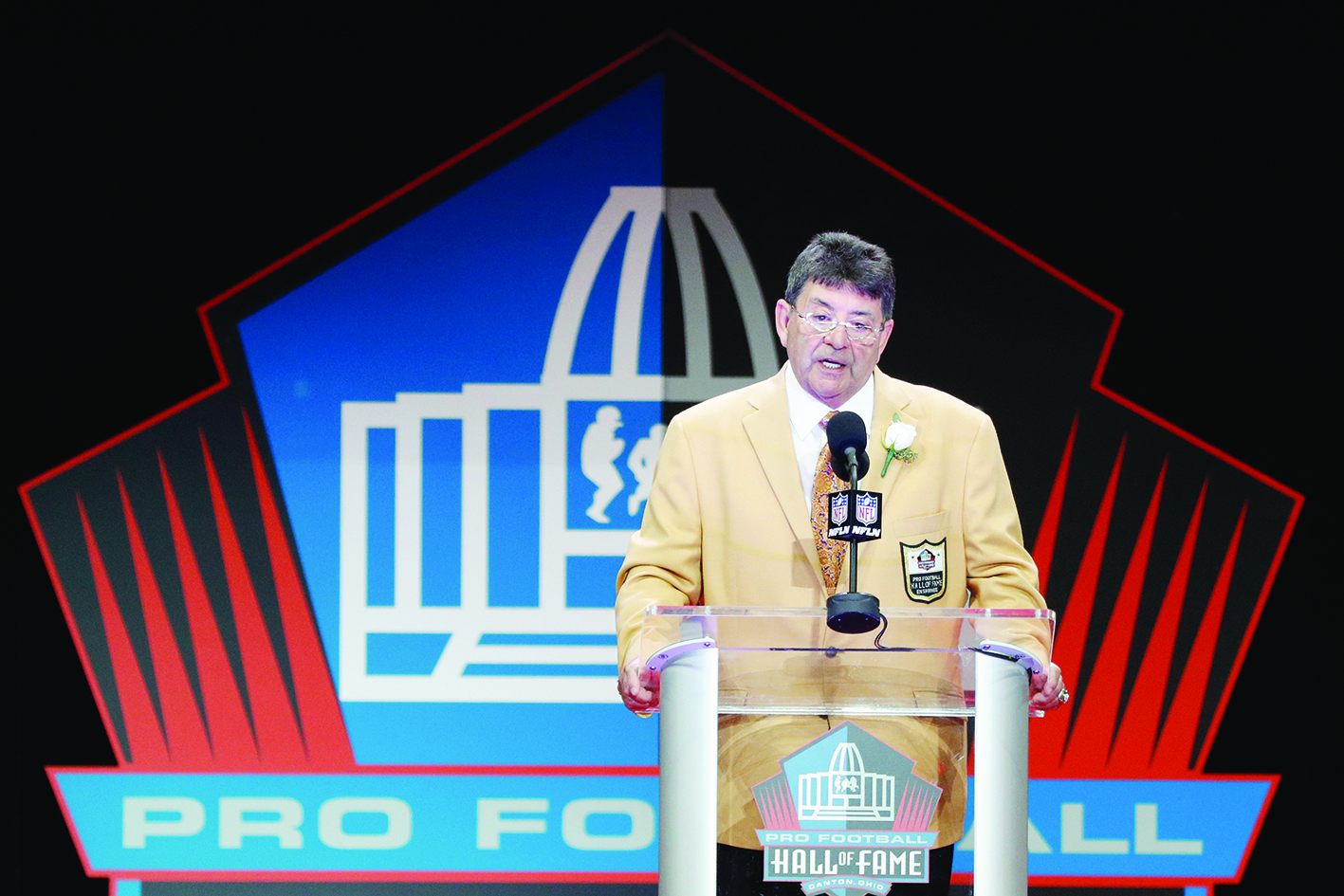 (FILES) In this file photo taken on August 6, 2016  Edward DeBartolo, Jr., former San Francisco 49ers Owner, speaks during his Pro Football Hall of Fame induction speech during the NFL Hall of Fame Enshrinement Ceremony at the Tom Benson Hall of Fame Stadium in Canton, Ohio. - US President Donald Trump on February 18, 2020 in Washington, DC, granted a full pardon to the former San Francisco 49ers owner convicted in a gambling fraud scandal. DeBartolo Jr., whose San Francisco 49ers won five Super Bowls under his leadership, stepped down as owner in 1997 after two Louisiana newspapers reported he would be indicted for gambling fraud. The White House announced the surprise decision on Tuesday, along with NFL greats Jerry Rice, Jim Brown, Ronnie Lott and Charles Haley. (Photo by Joe Robbins / GETTY IMAGES NORTH AMERICA / AFP)