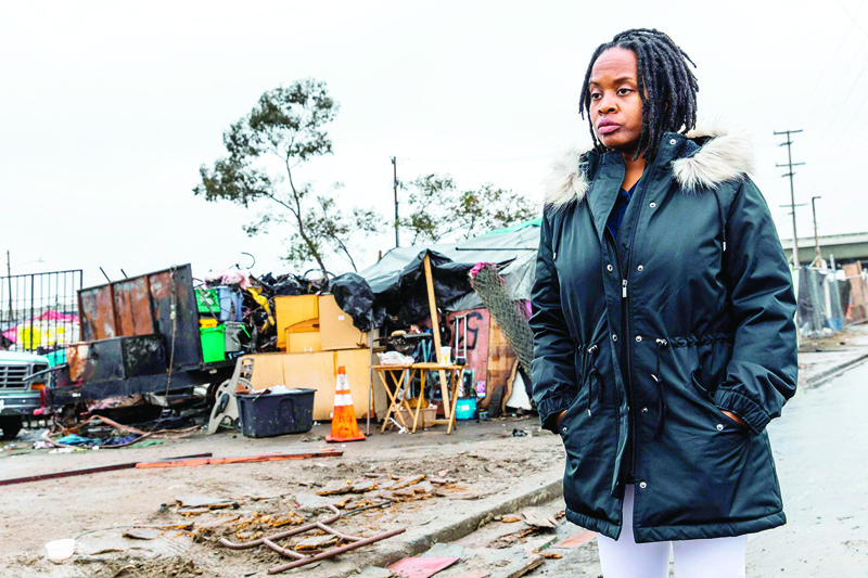 Carroll Fife, the director of the Oakland office for the Alliance of Californians for Community Empowerment walks outside a homeless encampment in Oakland, California on January 28, 2020. - When Dominique Walker moved back from Mississippi to her native California last year, she planned to pursue a nursing degree while caring for her two small children.nBut she and other moms and their children ended up living as squatters in a bold, high-profile protest against homelessness. According to city officials, an estimated 4,071 people were living on the street, in shelters or in their cars in 2019 in Oakland, a 47 percent increase in two years. (Photo by Philip Pacheco / AFP)