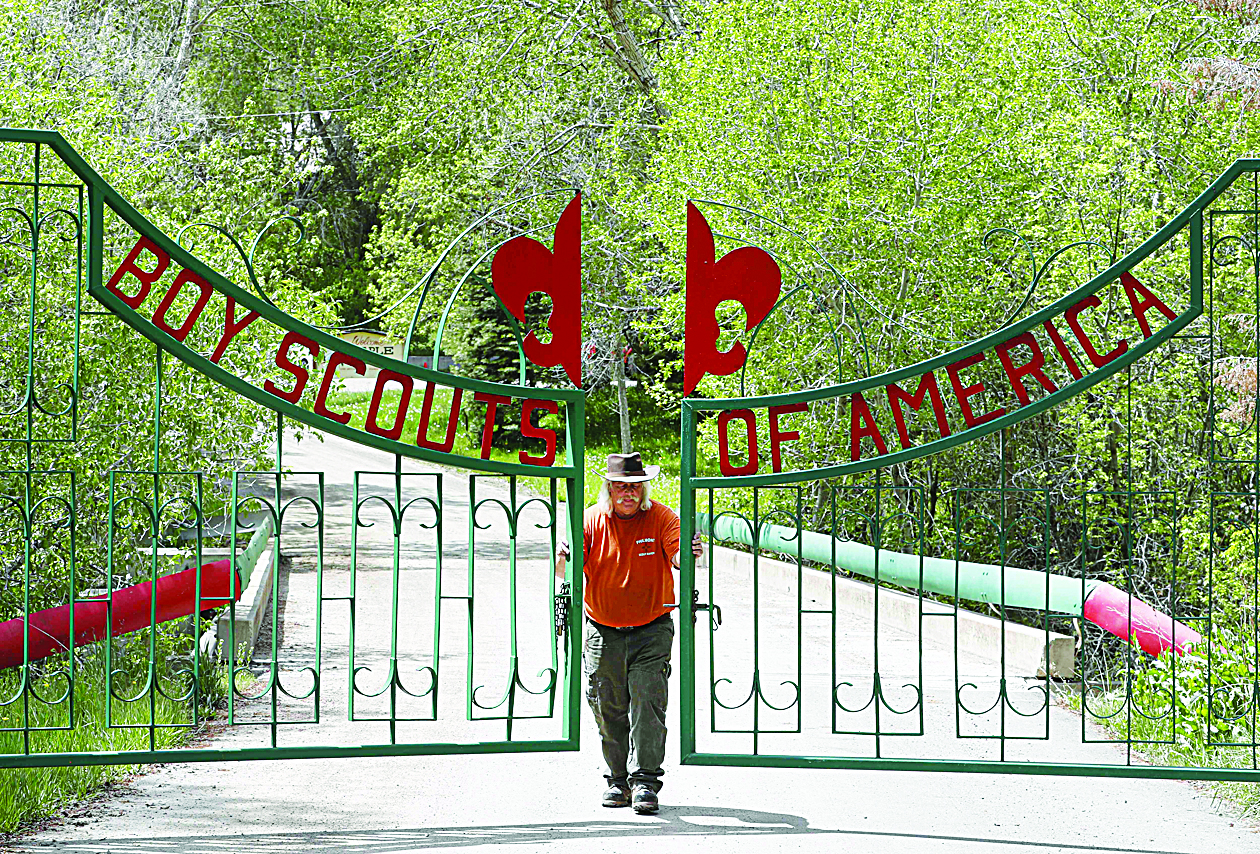 (FILES) In this file photo taken on May 08, 2018 Mark Veteto, Camp Ranger for the Maple Dell Scout Camp, owned by the Utah National Park Council of the Boy Scouts of America, closes the front gate for the day on May 9, 2018 outside Payson, Utah. - The Boy Scouts of America has filed for bankruptcy early February 18, 2020, a sign of the century-old organization's financial instability as it faces some 300 lawsuits from men who say they were sexually abused as scouts. The Scoutsí Chapter 11 petition, filed in Bankruptcy Court in Delaware, comes amid declining membership and a wave of new sex-abuse lawsuits after several states, including California, New York and New Jersey, recently expanded legal options for childhood victims to sue. (Photo by GEORGE FREY / GETTY IMAGES NORTH AMERICA / AFP)