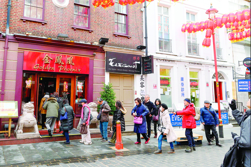 Tourists on a guided tour arrive at a restaurant in London's China Town district, on February 4, 2020. - As the deadly 2019-nCov strain of coronavirus has spread worldwide, it has carried with it xenophobia -- and Asian communities around the world are finding themselves subject to suspicion and fear. (Photo by JUSTIN TALLIS / AFP)