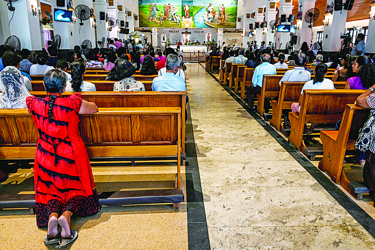 Christian devotees pray for a quick end to the spreading of the COVID-19 coronavirus during a special mass at the St. Anthony's Church in Colombo on February 15, 2020. (Photo by LAKRUWAN WANNIARACHCHI / AFP)