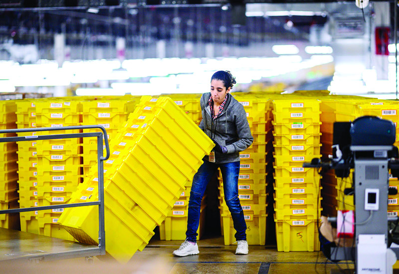 (FILES) In this file photo taken on February 5, 2019 a woman works at a fulfillment center at the 855,000-square-foot Amazon fulfillment center in Staten Island, one of the five boroughs of New York City. - American companies hired at a stunning pace in January, adding the most jobs in five years, according to data on February 5, 2020 from payrolls firm ADP. Private companies added 291,000 new hires last month -- surpassing the consensus forecast in spectacular fashion -- to post the biggest gain since December 2014, according to ADP's monthly report. (Photo by Johannes EISELE / AFP)
