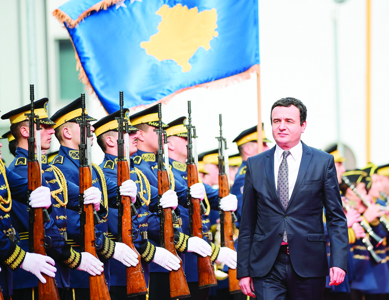 Newly elected Prime Minister of Kosovo Albin Kurti reviews Kosovo's honor guard during the handover ceremony in Pristina on February 4, 2020. - Albin Kurti was voted on February 3 Kosovo's new prime minister, raising hopes that a EU-mediated dialogue with Serbia, in stalemate for over a year, could resume and ease tensions in the war-scarred region. The 44-year old Kurti and his cabinet were elected four months after a snap election and only a day before the deadline, avoiding to push Kosovo into a political crisis. Once dubbed 'Kosovo's Che Guevara', Kurti vowed to tackle economy and unemployment, fight corruption and introduce a three-month compulsory military service. (Photo by Armend NIMANI / AFP)