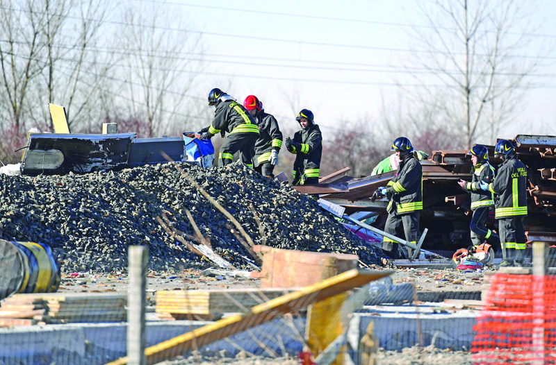 Italian firefighters remove rubbles from the wreckage of a derailed train, outside the city of Lodi, near Milan, northern Italy, on February 6, 2020. - Two people were killed and about 30 injured on February 6, 2020 when a high-speed train derailed near Milan in northern Italy, Italian media said. The accident occurred near the town of Lodi, about 50 kilometres (30 miles) south of Milan. The two people killed were rail workers on the train, the media said. (Photo by Miguel MEDINA / AFP)