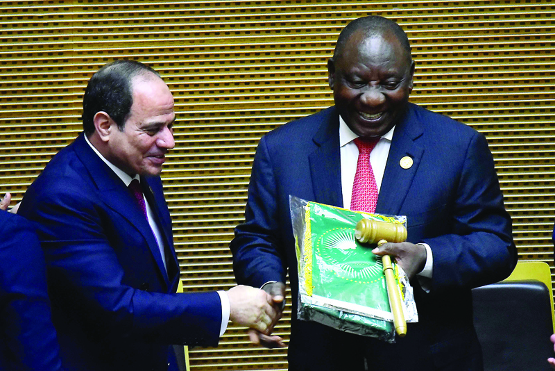 The outgoing chair of the African Union and the Egyptian President, Abdel Fattah el-Sisi (L), hands over the chairmanship to the incoming chair for the African Union and south African President, Cyril Ramaphosa, at the 33rd Ordinary session of the assembly of the African heads of States at the African Unioun headquarters in Addis Ababa on February 9, 2020. (Photo by MICHAEL TEWELDE / AFP)