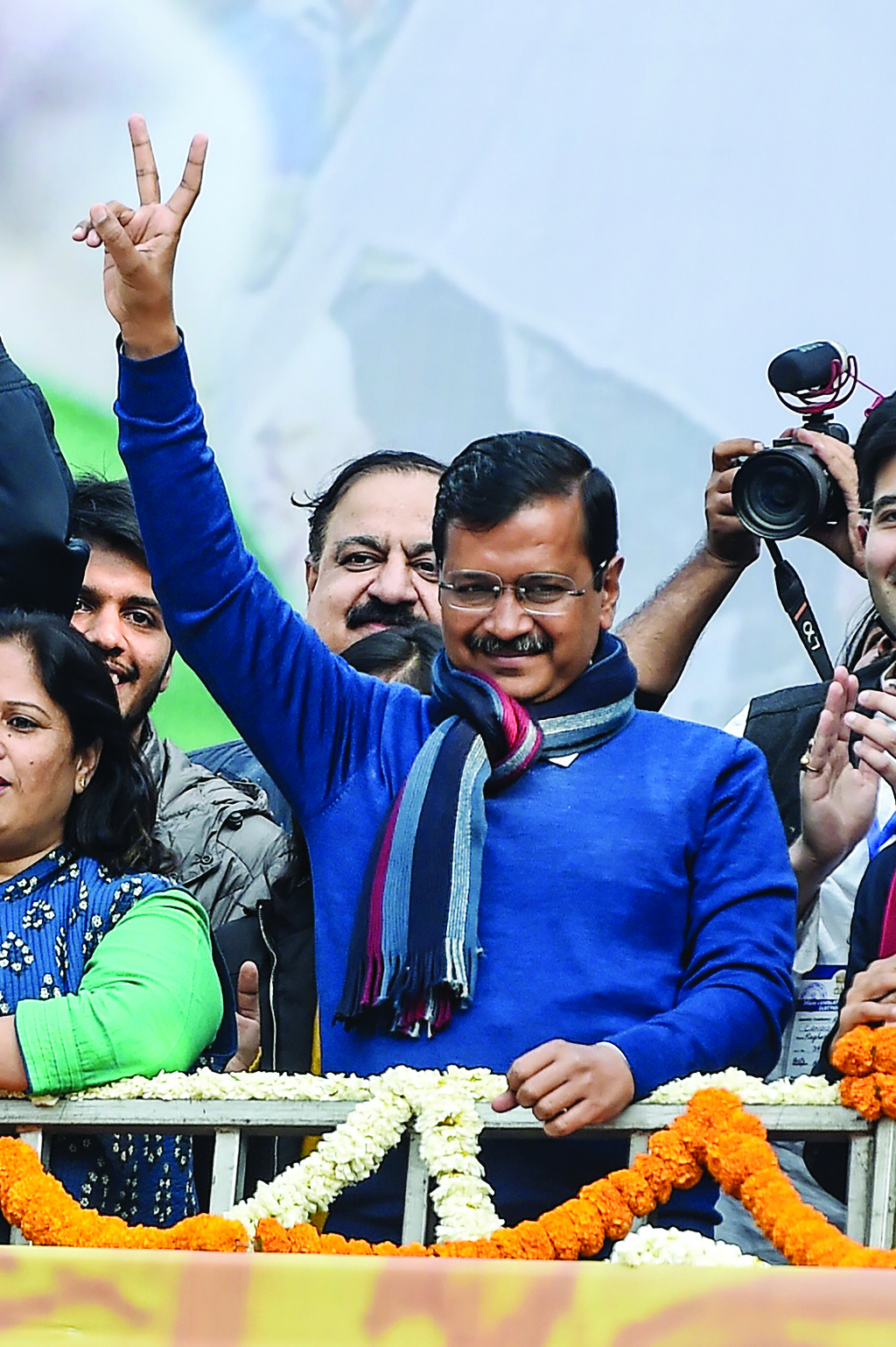 Aam Aadmi Party (AAP) chief Arvind Kejriwal gestures towards his supporters at the party headquarters in New Delhi on February 11, 2020. (Photo by Money SHARMA / AFP)