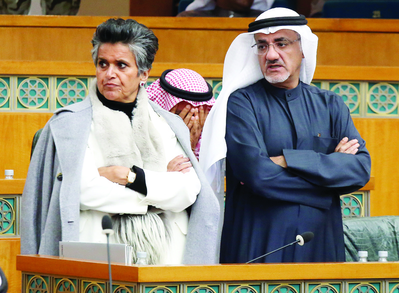 Kuwaiti Mps Safaa al-Hashem (L) and Khalil Abul during a parliament session at Kuwait's national assembly in Kuwait City on February 4, 2020.