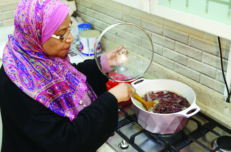 Moudi al-Miftah, a 64-year-old journalist, cooks locust at her home in Al-Ahmadi, some 35 kilometres south of Kuwait City, on January 25, 2020. - Some people like them baked, others prefer them dried. But while locusts, a surprisingly nutritious edible insect, are considered a delicacy by some in Kuwait, others are repulsed by the crunchy culinary offering. Locust consumption is dwindling across Kuwaiti society, particularly among the younger generation, many of whom are disgusted by the prospect. They are consumed in many parts of the world and are a staple of some cuisines. Experts say they are an excellent, energy-efficient source of protein. (Photo by YASSER AL-ZAYYAT / AFP)
