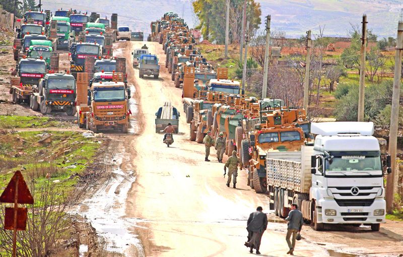 A Turkish military convoy is pictured in the village of al-Mastumah, about seven kilometres south of the city of Idlib on February 8, 2020. (Photo by AAREF WATAD / AFP)