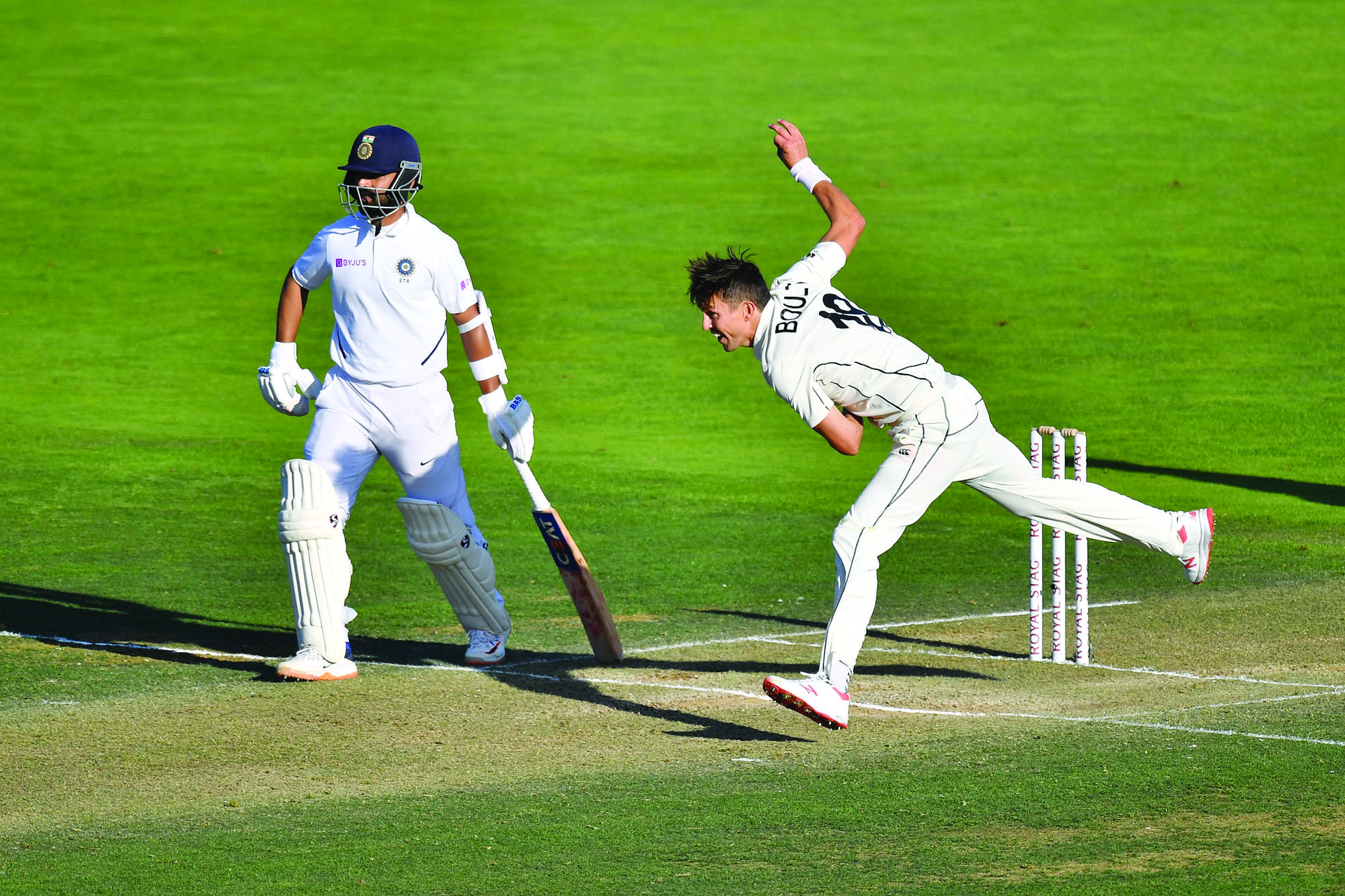 New Zealand's Trent Boult (R bowls with India's Ajinkya Rahane during day three of the first Test cricket match between New Zealand and India at the Basin Reserve in Wellington on February 23, 2020. (Photo by Marty MELVILLE / AFP)