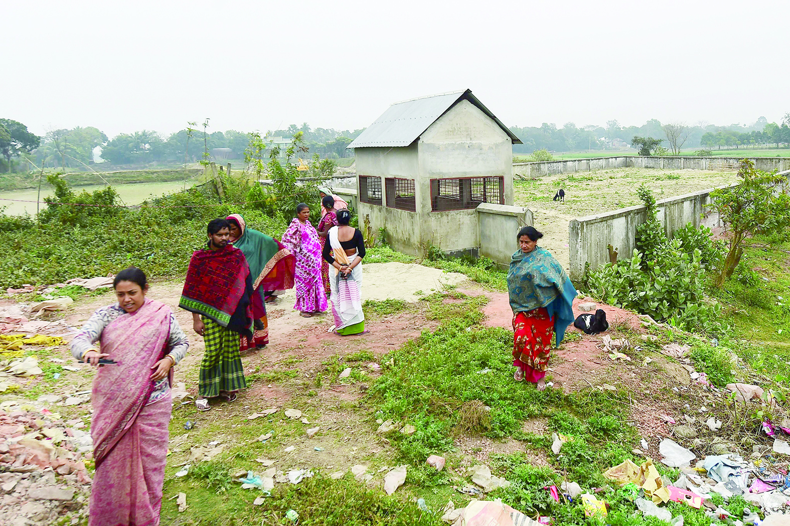 This photograph taken on February 8, 2020 shows Jhumur Begum (L), who heads a sex workers group, walking with other members next to a graveyard used for the burial of sex workers in Daulatdia, Rajbari District, 110 kms (70 miles) west of Dhaka. - Daulatdia is one of about 12 legal but frowned upon brothel areas operating in the country. (Photo by Munir UZ ZAMAN / AFP) / TO GO WITH Bangladesh-prostitution-death-religion,FOCUS by Shafiqul ALAM
