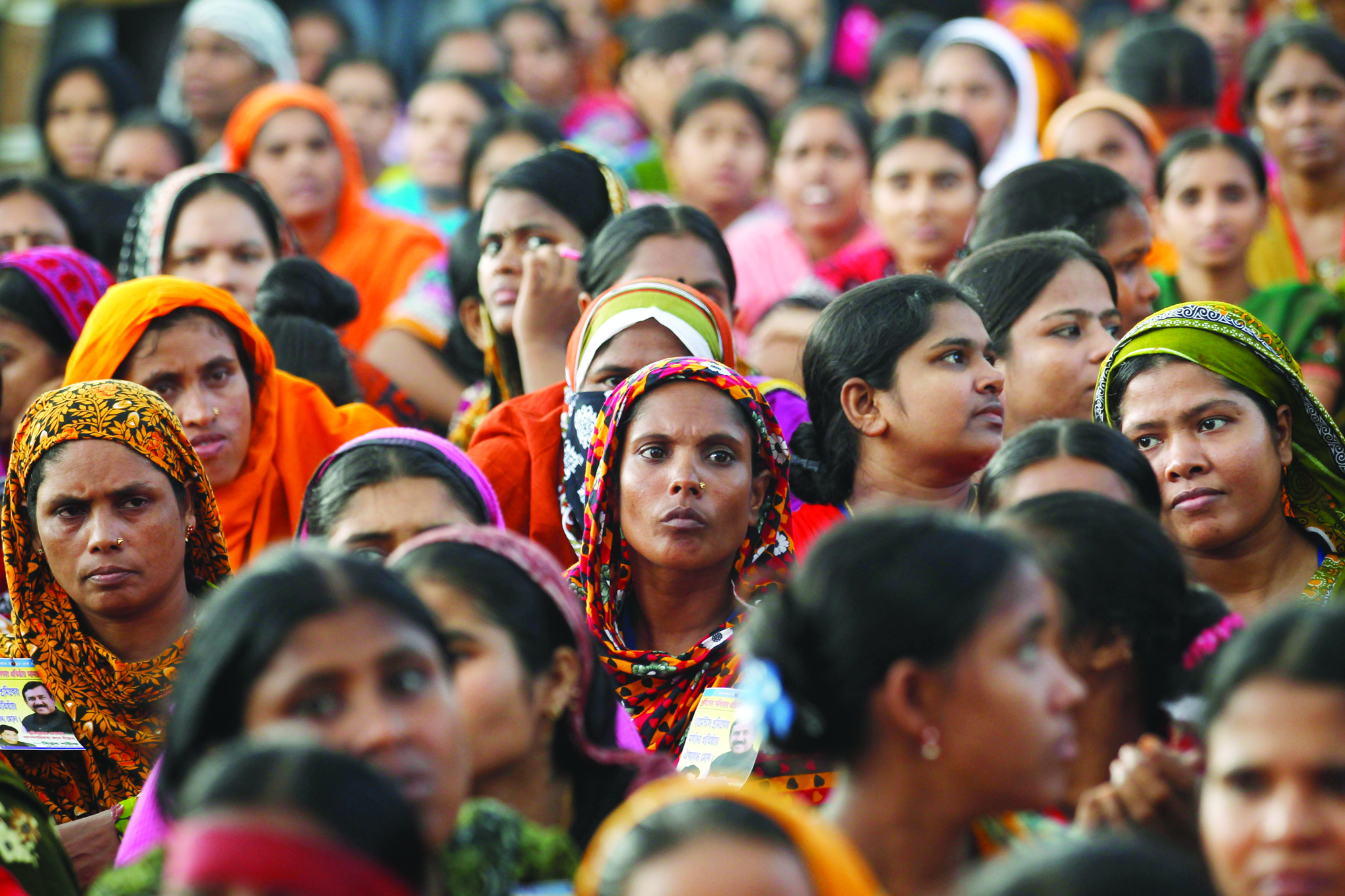 Garment workers listen to speakers during a rally demanding an increase to their minimum wage in Dhaka September 21, 2013. EUTERS/Andrew Biraj