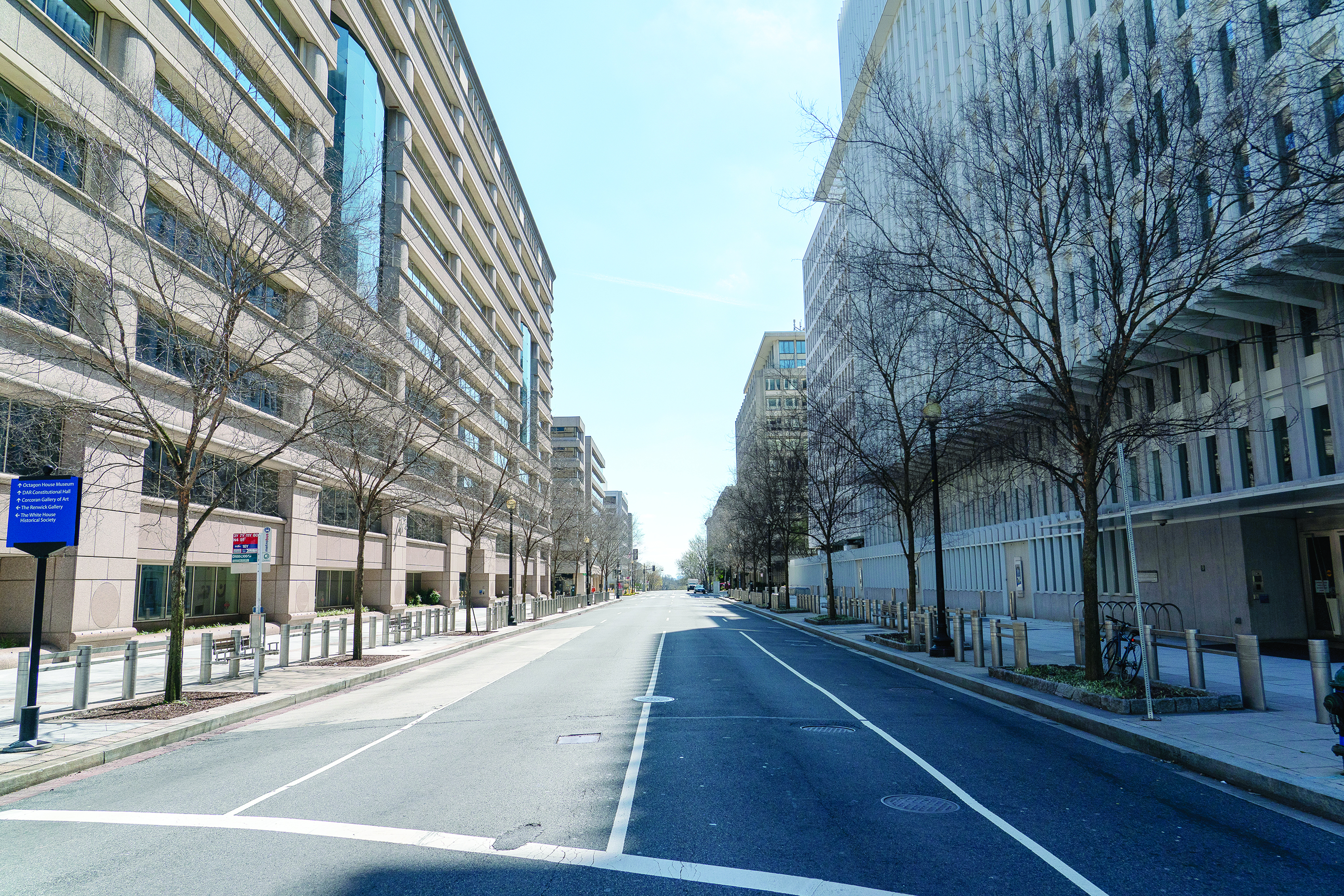 An empty downtown street is seen near the World Bank on March 26, 2020, in Washington, DC. - President Donald Trump, keen for an early lifting of economically costly social distancing measures against the coronavirus, said he would propose dividing the United States by risk levels. In a letter to state governors released by the White House, Trump said that better testing now allows the mapping of virus threat on a local level. (Photo by Alex Edelman / AFP)