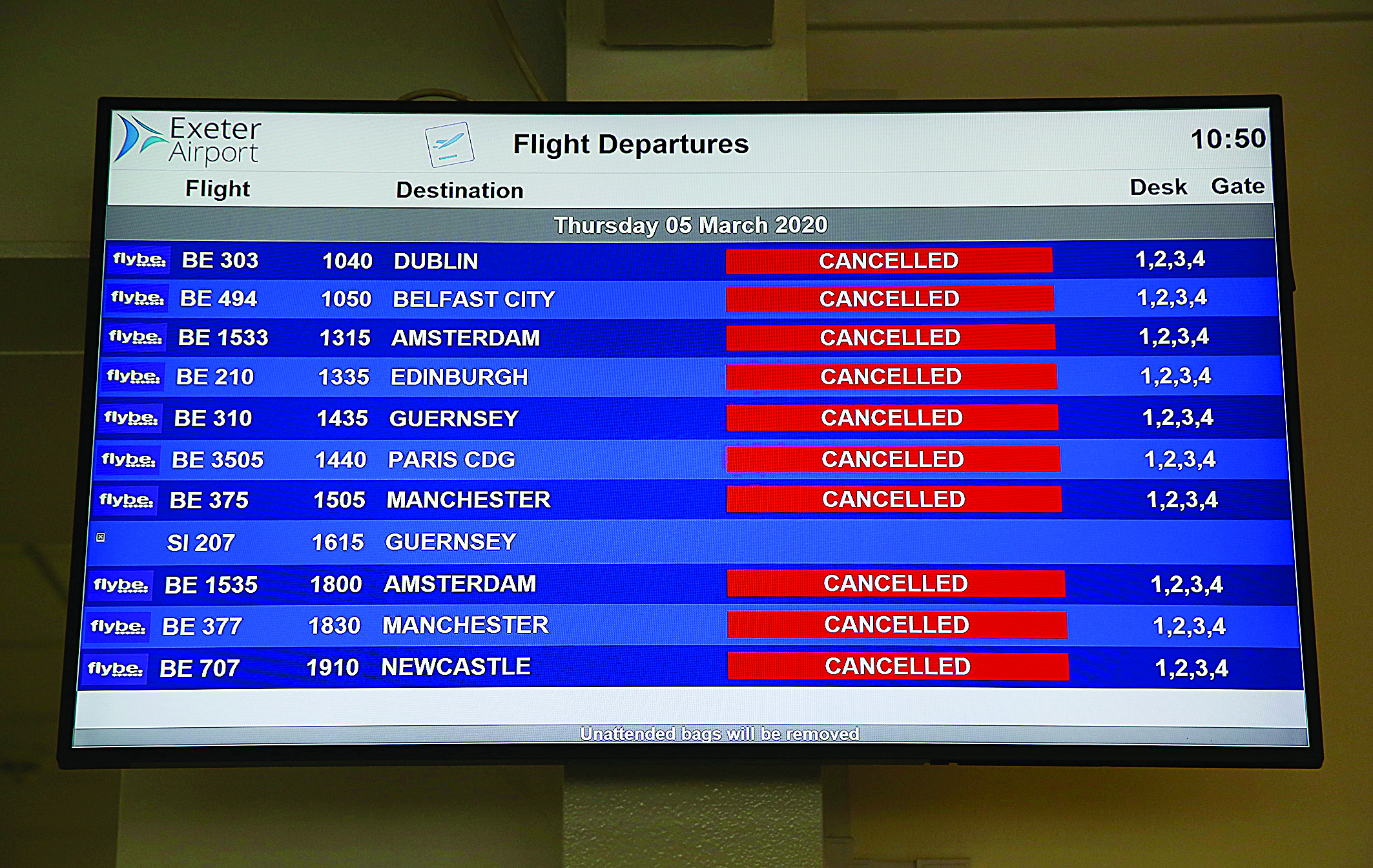 An electronic flight departure board displays 'cancelled' status's for all Flybe flights due to have taken-off from Exeter Airport in Exeter, south-west England on March 5, 2020, following the news that the airline had collapsed into bankruptcy. - British regional airline Flybe crashed into bankruptcy Thursday after the deadly coronavirus proved to be the final nail in its coffin. The biggest operator of UK domestic flights said it has sunk into administration -- a last-ditch process aimed at salvaging at least some of the company. (Photo by GEOFF CADDICK / AFP)
