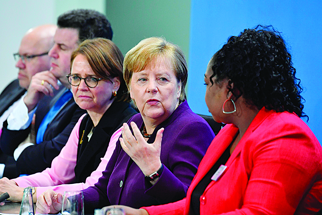 (L-R) German Economy Minister Peter Altmaier, German Labour Minister Hubertus Heil, German State Minister for Migration, Refugees and Integration Annette Widmann-Mauz, German Chancellor Angela Merkel and Sylvie Nantcha, head of The African Network of Germany (TANG), give a press conference at the end of a summit on integration at the Chancellery in Berlin on March 2, 2020. - German Chancellor Angela Merkel is hosting the summit, where politicians, scientists, representatives of the economy, the media, social associations and of the civil society meet to discuss issues of the  country's integration policy. (Photo by John MACDOUGALL / AFP)