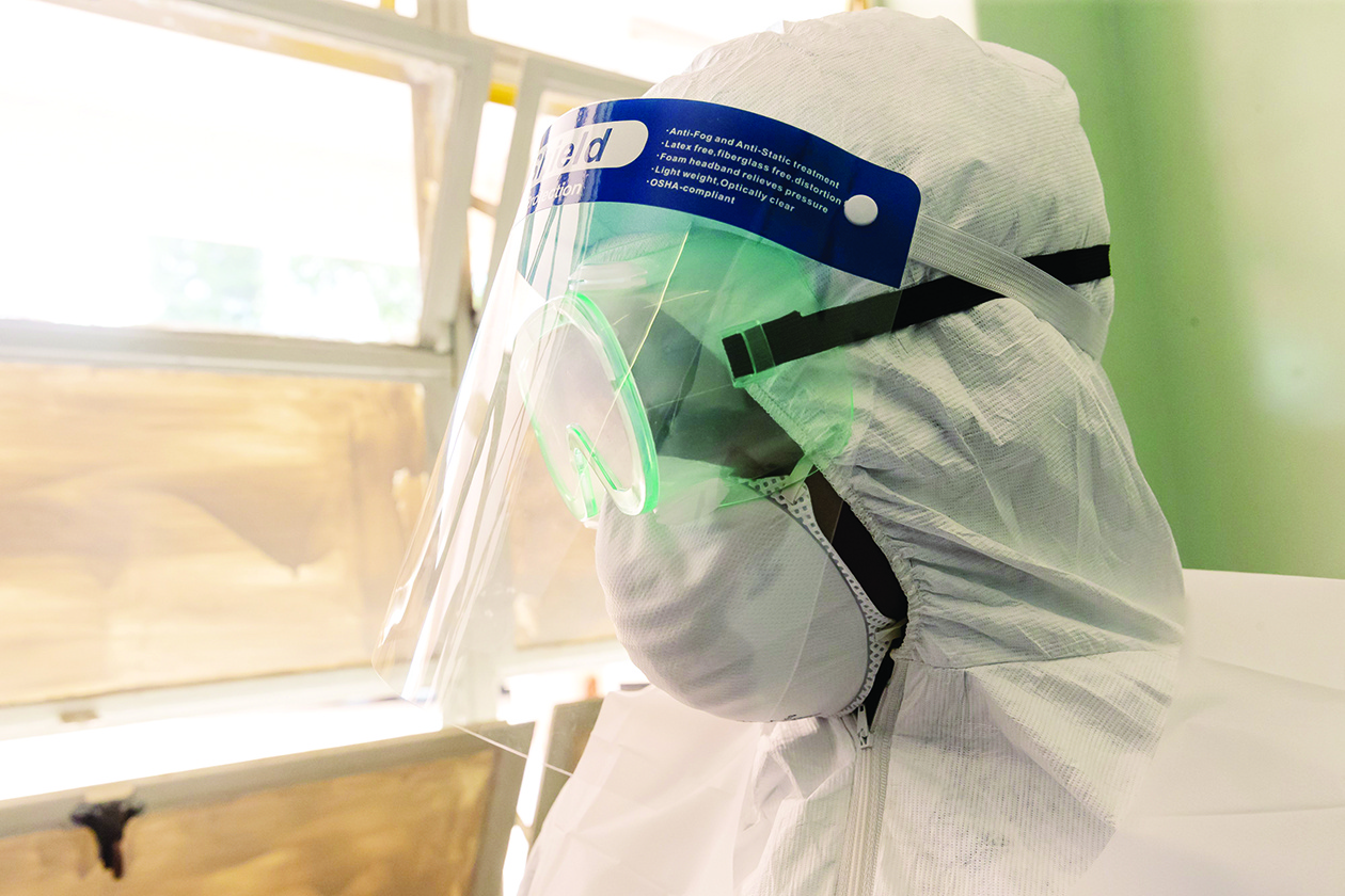 A medical staff member wears protective equipment  at the Wilkins Infectious Diseases Hospital in Harare on March 11, 2020,  as they demonstrate their state of preparedness to treat the COVID-19 coronavirus in the event the epidemic reaches Zimbabwe where five suspected cases have tested negative. (Photo by Jekesai NJIKIZANA / AFP)