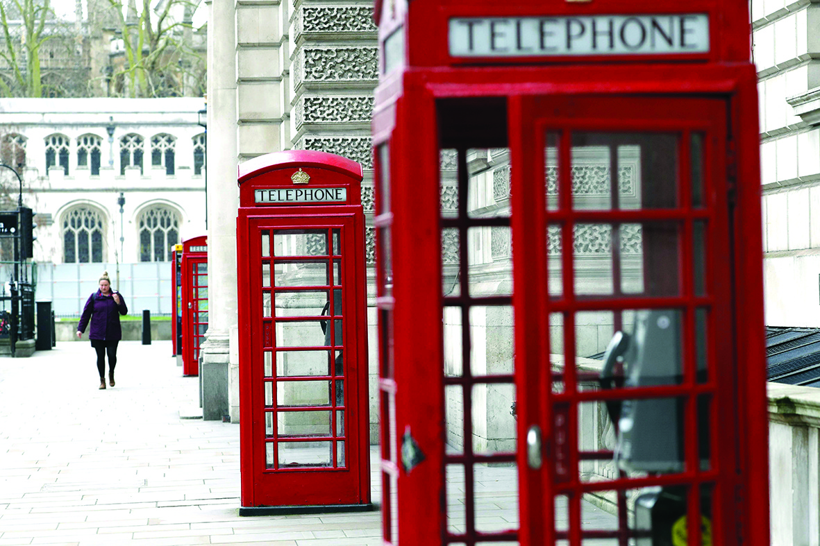 A picture shows phone boxes on a quiet street in Westminster in London on March 18, 2020 amid the coronavirus outbreak. - The British government will on Wednesday unveil a raft of emergency powers to deal with the coronavirus epidemic, including proposals allowing police to detain potentially infected people to be tested. (Photo by Adrian DENNIS / AFP)