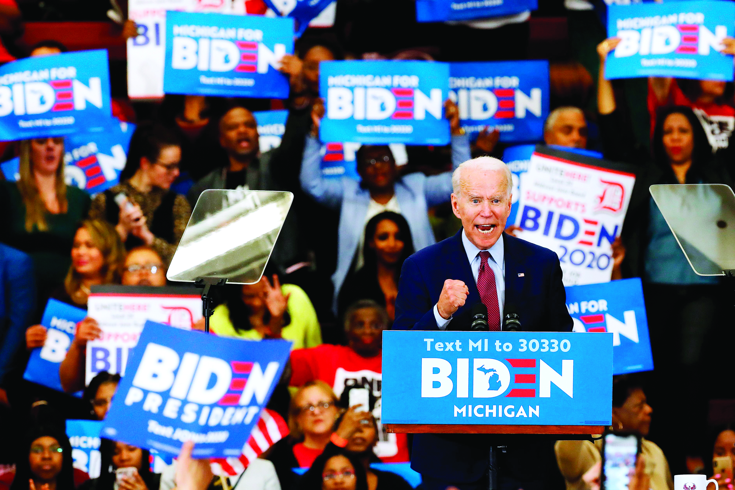 (FILES) In this file photo taken on March 09, 2020 Democratic presidential candidate former Vice President Joe Biden gestures as he speaks during a campaign rally at Renaissance High School in Detroit, Michigan. - Joe Biden won the Arizona Democratic primary over Bernie Sanders, giving him a sweep of the three US states which voted on March 17, 2020, TV networks said. With 56 percent of precincts reporting in Arizona, Biden led Sanders by 42.6 percent to 30.3 percent, according to New York Times figures.nBiden also won primaries in Florida and Illinois on Tuesday to open up a commanding lead over Sanders in the race for the Democratic presidential nomination. (Photo by JEFF KOWALSKY / AFP)