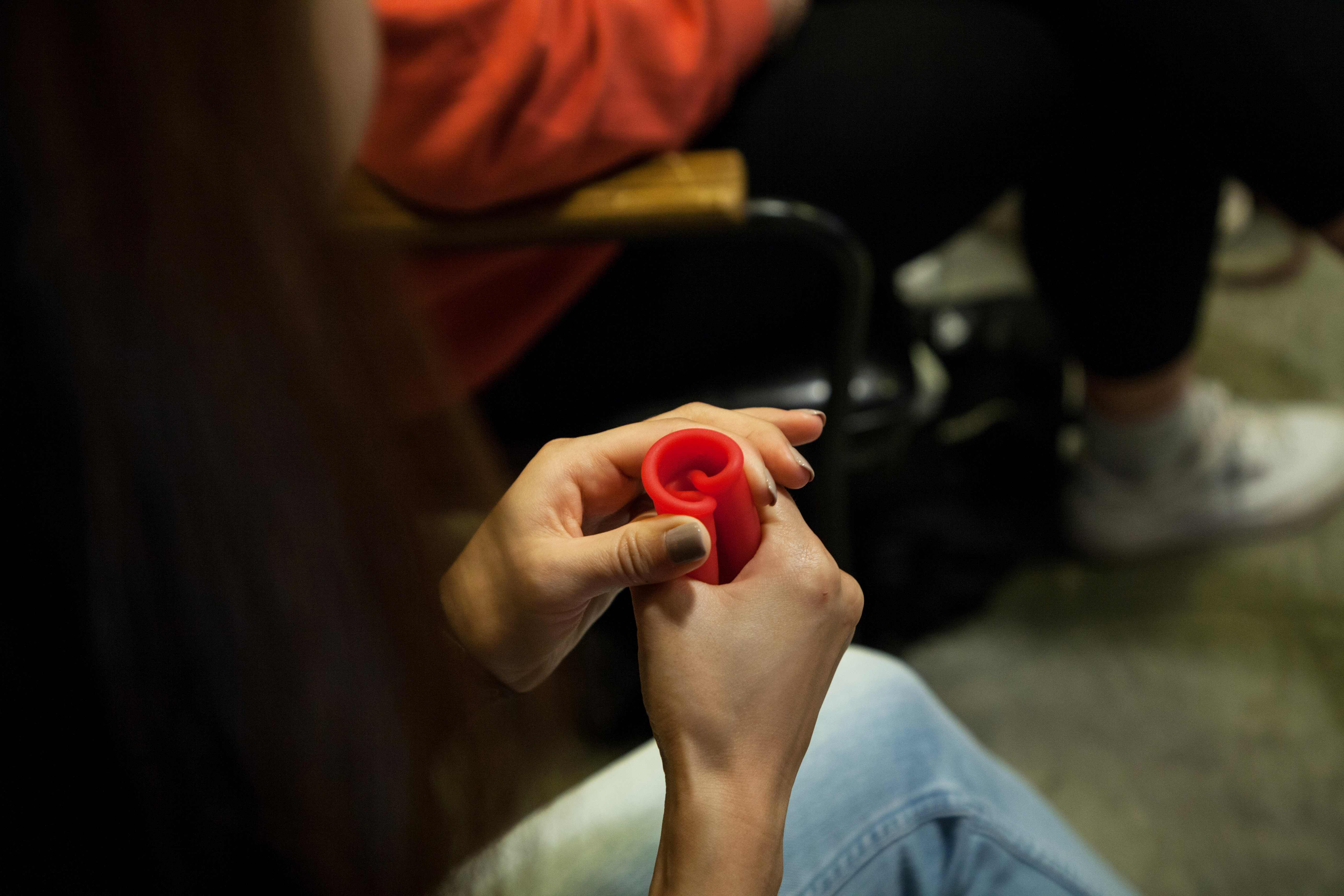 This picture taken on February 27, 2020 shows a participant practising how to fold a menstrual cup at a workshop held by LUUNA Naturals Olivia Cotes-James in Hong Kong. - No more euphemisms, no more opaque marketing, no more superstitions, and no glossing over cramps, bleeding, or pain: Reframing current attitudes is vital for female empowerment and health, as well as the environment, says the 29-year-old founder of LUÜNA Naturals, which hails itself as Asia's first period care company with an all-female leadership team. (Photo by Veronica SANCHIS BENCOMO / AFP) / TO GO WITH Women-activism-economy-HongKong-environment-health,INTERVIEW by Liz THOMAS
