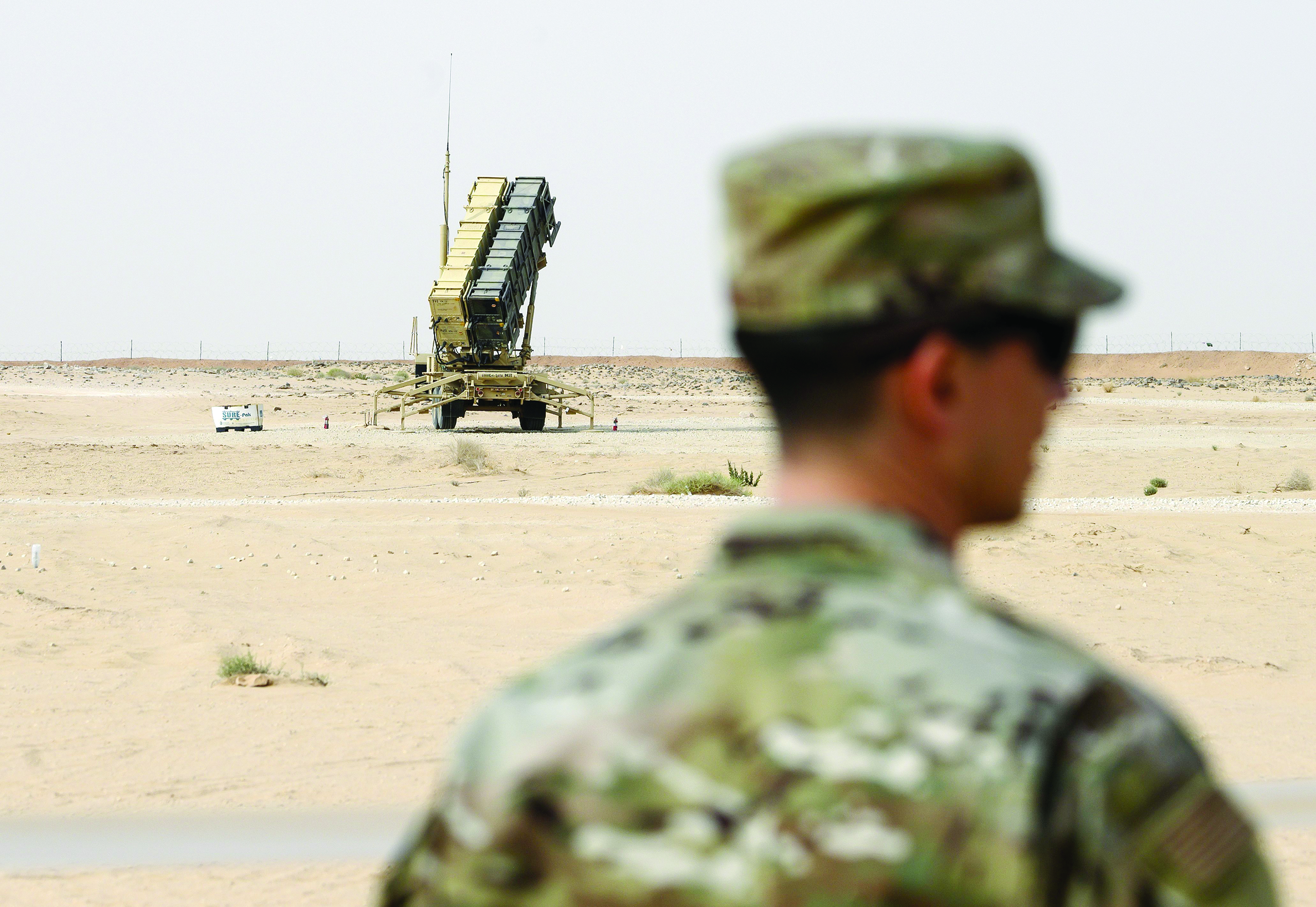 (FILES) In this file photo taken on February 20, 2020, a member of the US Airforce looks on near a Patriot missile battery at the Prince Sultan air base in Al-Kharj, in central Saudi Arabia. - Saudi air defences intercepted ballistic missiles over Riyadh and a city on the Yemen border late on March 28, leaving at least two civilians wounded in the capital that is under curfew in a bid to curb the spread of the coronavirus. Multiple explosions shook Riyadh in the attack, which the Saudi-led military coalition blamed on Yemen's Iran-aligned Huthi rebels. It was the first major assault on Saudi Arabia since the Huthis offered last September to halt attacks on the kingdom after devastating twin strikes on Saudi oil installations. (Photo by ANDREW CABALLERO-REYNOLDS / POOL / AFP)